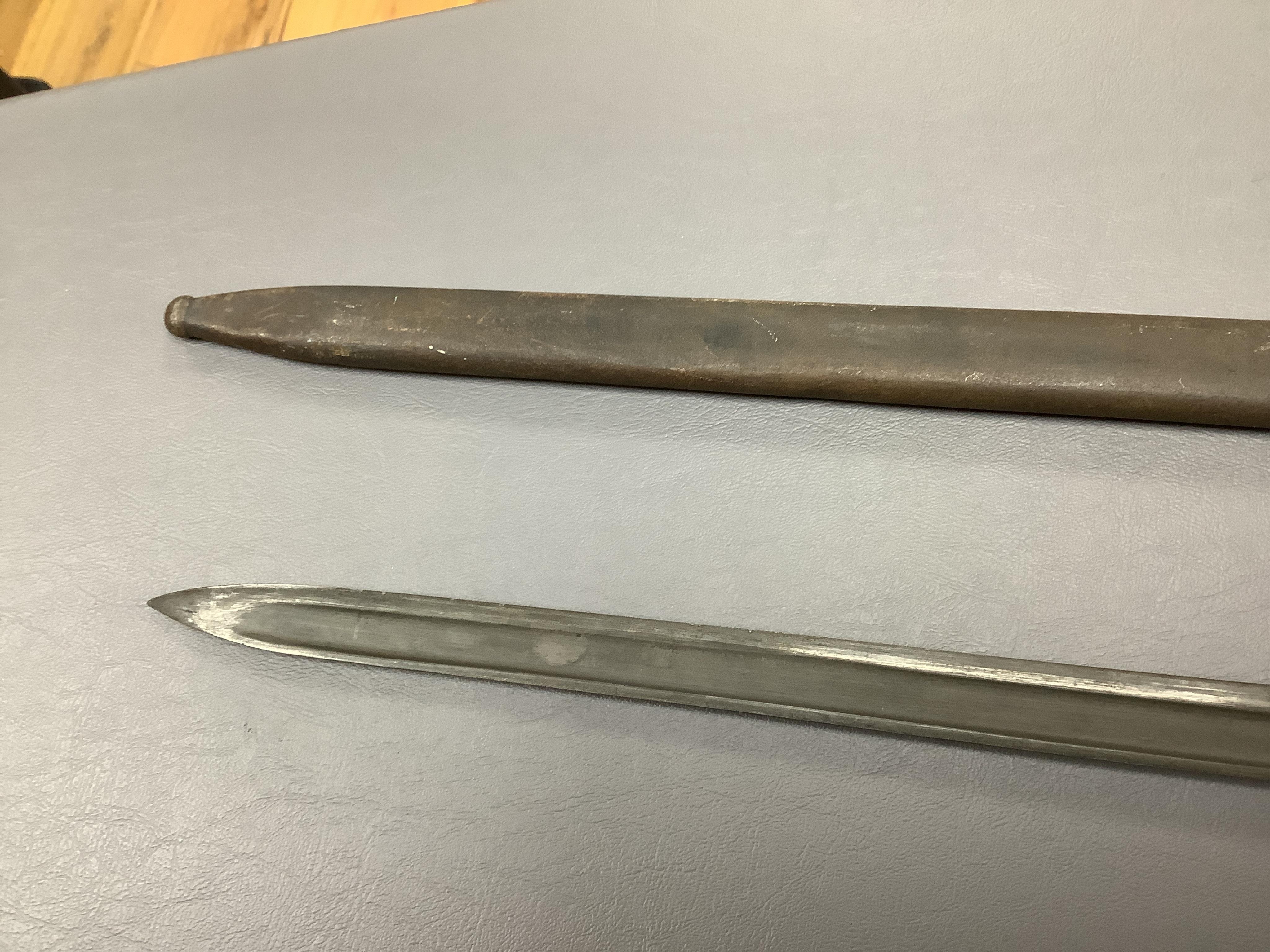 A First World War Turkish army officer’s sword, with pipe back blade, regulation iron guard pierced with crescent and moon, chequered horn grips, in its iron scabbard, together with an unidentified bayonet in its scabbar